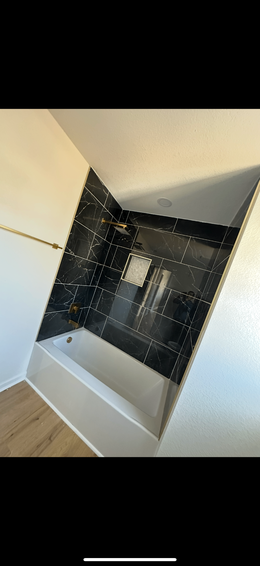 Marble tub surround with gold fixtures